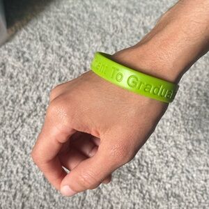 Bright green “Commitment to Graduate” silicone bracelet